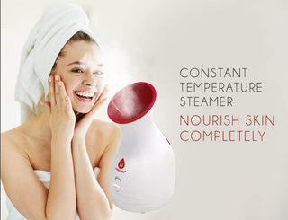A woman with a towel wrapped around her hair is using the Pursonic Pore Purifying Facial Steamer. She is smiling and touching her face. Next to her, there's text that reads "Pore Purifying Facial Steamer: Nourish Skin Completely." The steamer is emitting visible steam, offering a moisturizing spa experience while tackling blackheads.