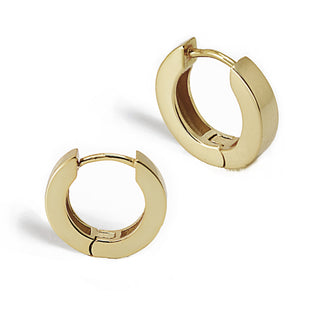 The Essential Huggies from Sonia Hou Jewelry are small, round, gold huggie earrings featuring a hinge closure. Presented against a white background, these lightweight and versatile earrings boast a smooth and polished finish.