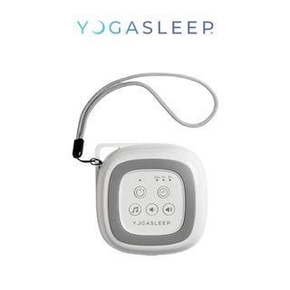 A Yogasleep Travelcube Portable Sound Machine with a gray and white design is shown. The device features buttons for power, volume control, and sound selection. It’s a travel essential with an attached lanyard for easy carrying, and the Yogasleep logo is displayed above it.