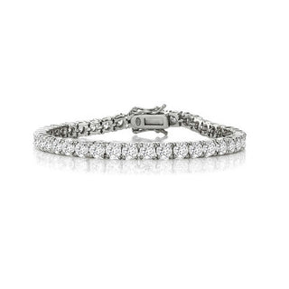The Genevieve White Gold Plated Tennis Bracelet features a single row of round, sparkling cubic zirconia stones. This elegant accessory is designed with a secure clasp for fastening and boasts an elegant, classic appearance, beautifully complemented by the uniform glint of the gemstones.